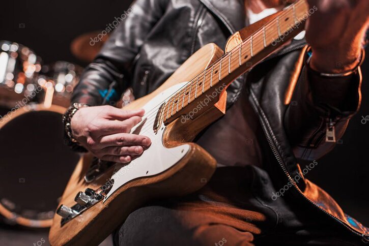 Row of used guitars on stands
