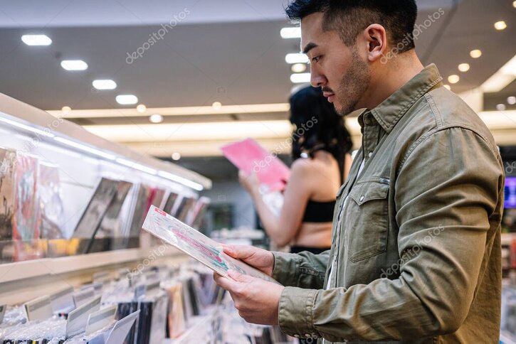Stack of CDs and vinyl records