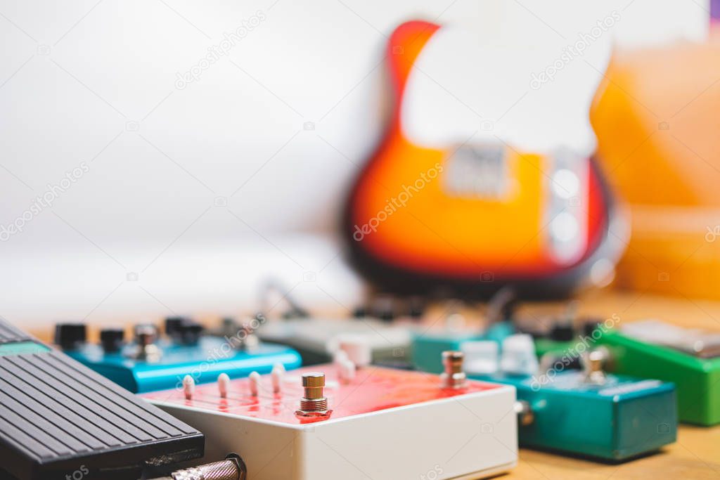Colorful guitar effect pedals lined up on the floor