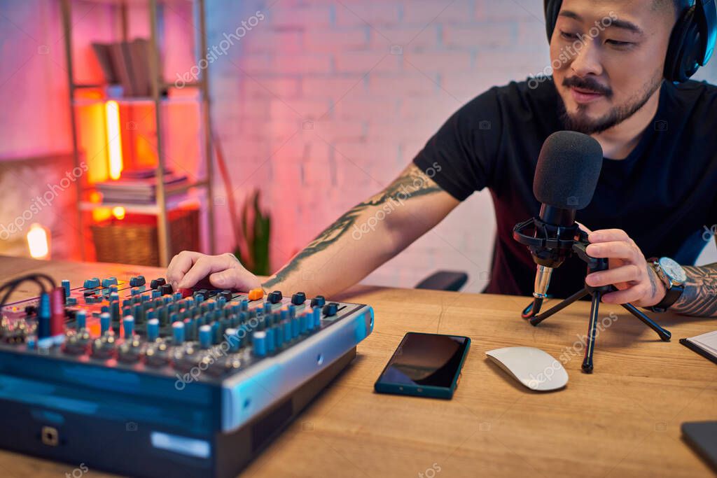 Headphones and a compact audio mixer on a desk
